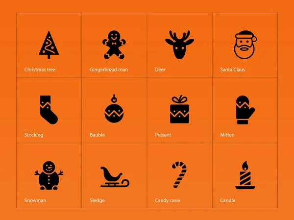 Iconos de Navidad sobre fondo naranja . — Vector de stock