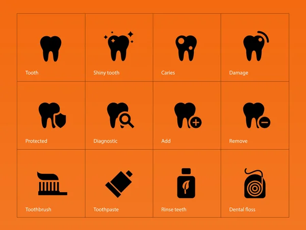 Ícones de dentes no fundo laranja . — Vetor de Stock