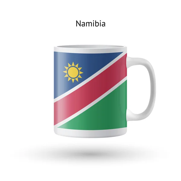 Kubek z pamiątkami flaga Namibii na białym tle. — Wektor stockowy