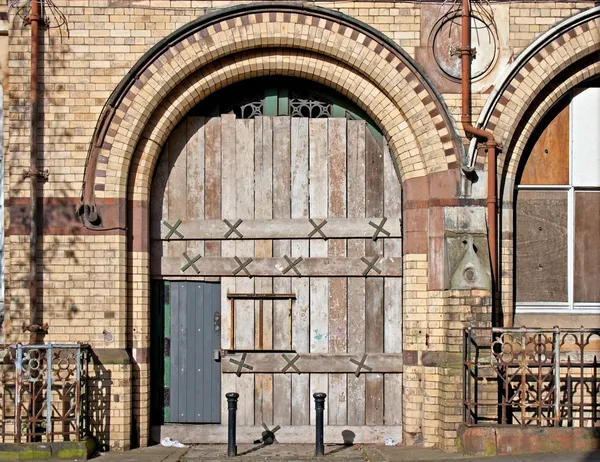 Old boarded up arched doorway — Stock Photo, Image