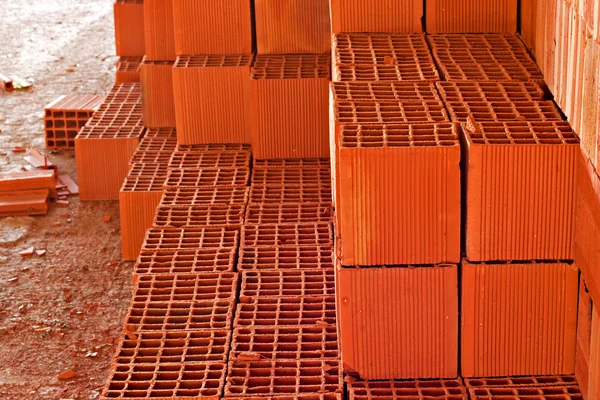 Stack of red building blocks inside construction site — Stock Photo, Image