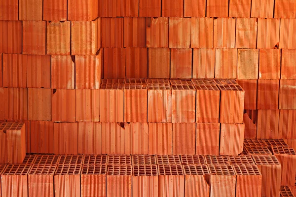 Stack of red building blocks inside construction site — Stock Photo, Image