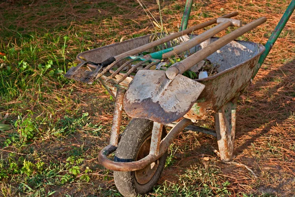 Ferramentas de jardinagem em velho carrinho de mão enferrujado — Fotografia de Stock