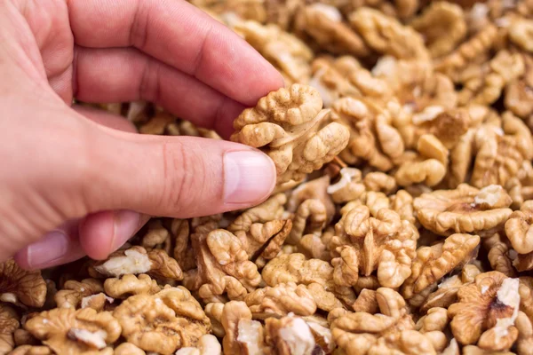 Closeup Hand With Walnuts In A Pile — Stock Photo, Image