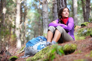 Person hiking - woman hiker sitting in forest clipart