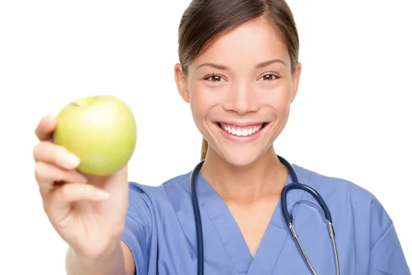 Nurse giving apple — Stock Photo, Image