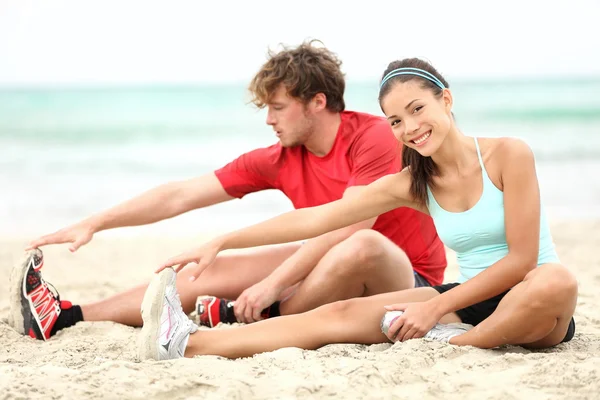 Couple training on beach Royalty Free Stock Images