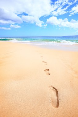 Beach travel vacation concept - footsteps in sand clipart