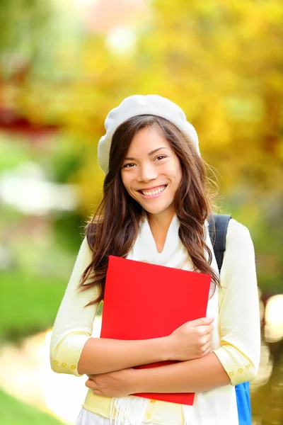 Young woman student in autumn park — Stok fotoğraf