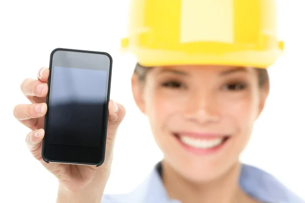 Engineer woman showing smart phone — Stock Photo, Image