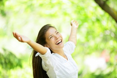 Carefree elated cheering woman in spring or summer clipart
