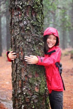 Happy female tree hugger clipart