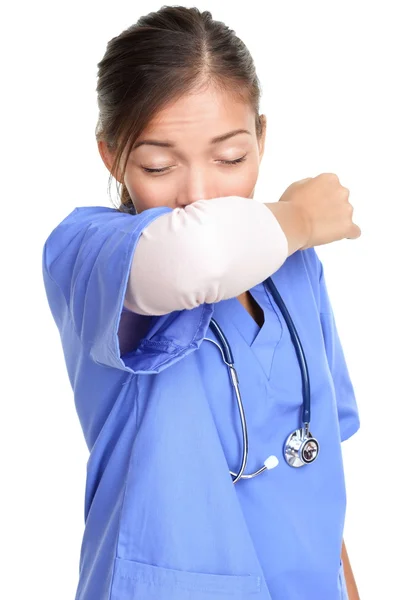 Sneezing woman medical nurse doing elbow sneeze — Stock Photo, Image