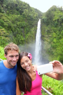 Tourists couple taking photo on Hawaii clipart