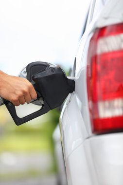Gas station pump - filling gasoline in car clipart