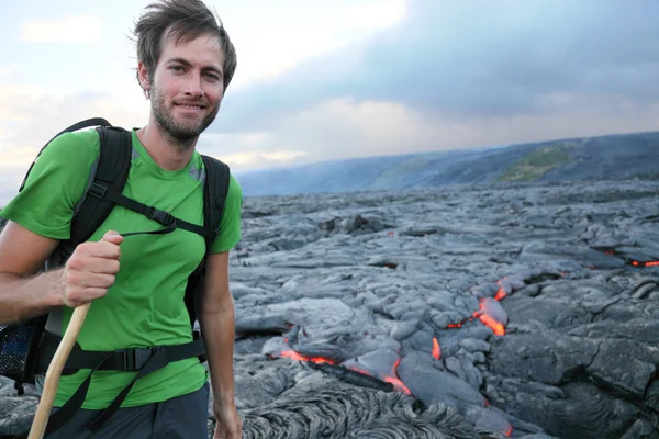Hawaii hiker hiking by flowing lava — Stock Photo, Image