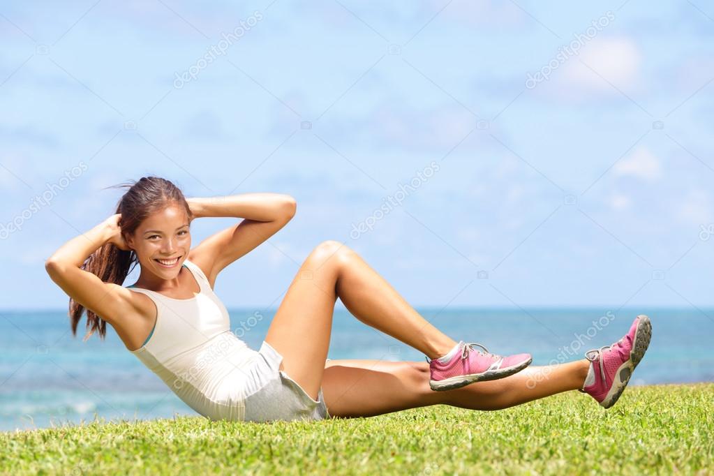 Fitness. Woman Doing Workout Exercise On Street. Beautiful Fit Girl Wearing  Fitness Tracker, Headphones And Armband Phone Case Stretching Her Long Legs  Outdoors. Sports Devices. High Resolution Stock Photo, Picture and Royalty