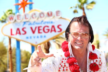 Elvis impersonator man in front of Las Vegas sign clipart