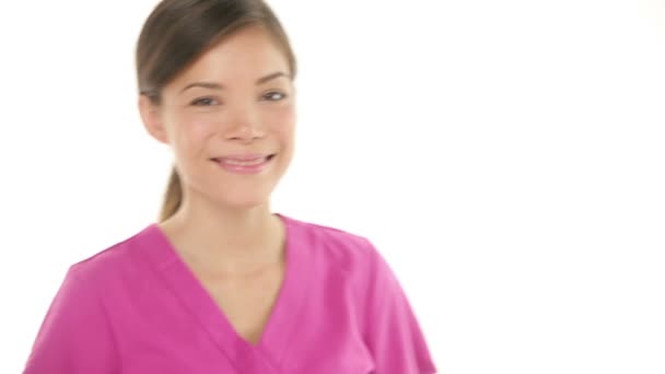 Woman doctor in scrubs walking in giving thumbs up — Stock Video