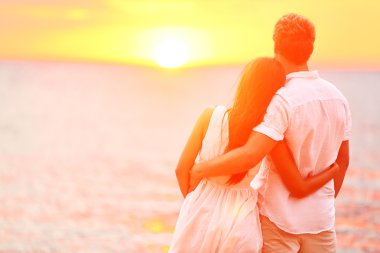 Honeymoon couple romantic in love at beach sunset clipart