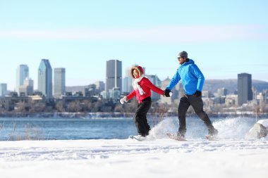 Couple snowshoeing in montreal clipart