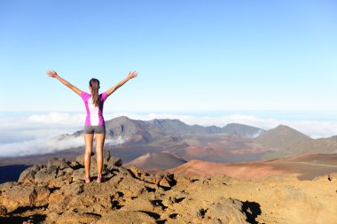 Hiking woman on top happy and celebrating success clipart