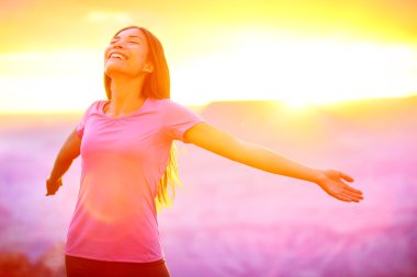 Happy people - free woman enjoying nature sunset clipart