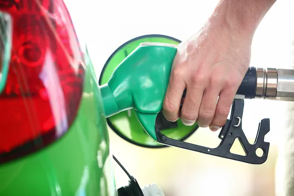 Gas station pump - filling gasoline in green car Stock Photo