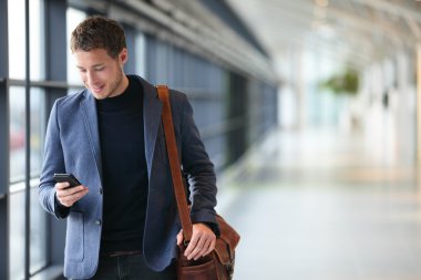 Man on smart phone - business man in airport clipart