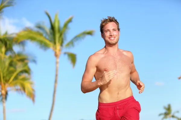 Beach man running smiling happy in swimwear — Stock Photo, Image