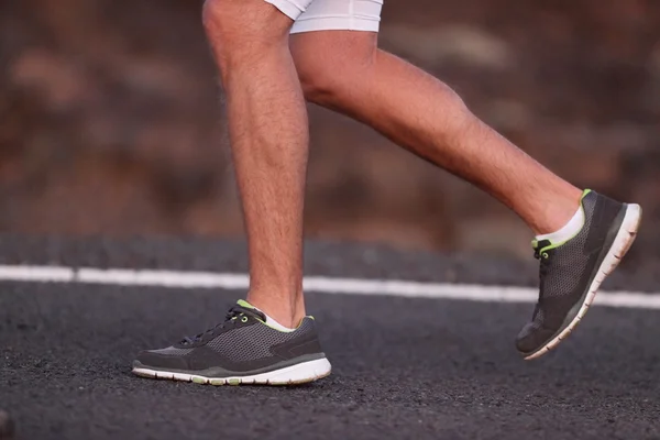 Runner feet running on road closeup on shoe — Stock Photo, Image