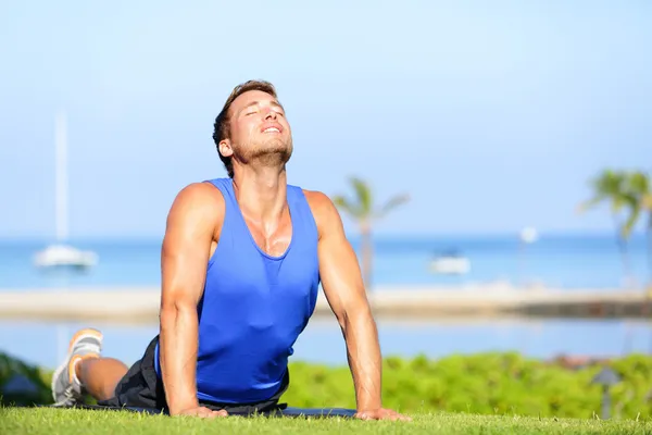 Fitness yoga man in cobra pose stretching abs — Stock Photo, Image