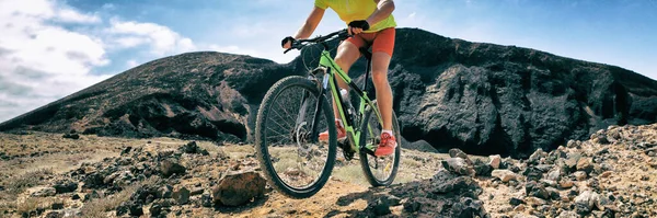 Mountain bike MTB biking athlete man in mountains landscape jumping riding bicycle. Professional bicycle rider training outdoors. Sport and fitness panoramic banner background. — Stock Photo, Image