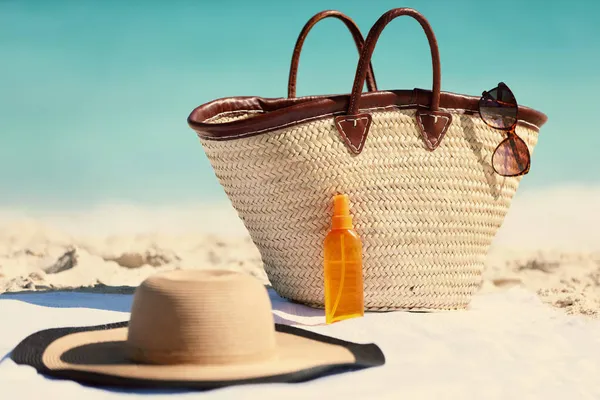 Аксессуары для отдыха по уходу за солнцем, чтобы принести в вашей пляжной сумке для Карибского отдыха - солнцезащитные очки, шляпа, солнцезащитный крем солнечный лосьон для защиты от солнца. — стоковое фото
