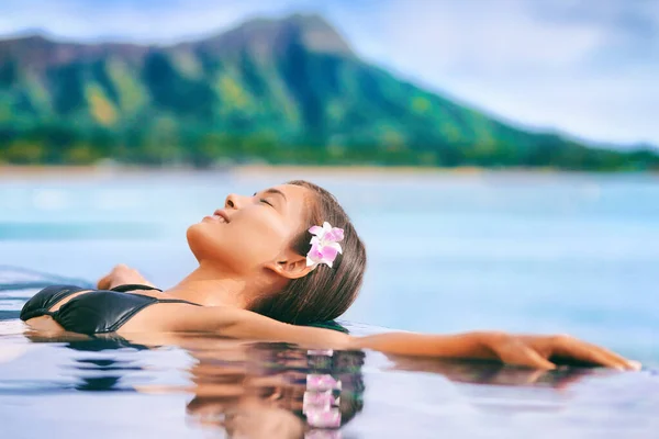 Hawaii vakantie luxe resort reizen Aziatische toeristische meisje ontspannen in hotel infinity zwembad door Waikiki strand in Honolulu, Oahu. Verenigde Staten reizen. — Stockfoto