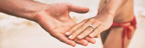 Diamond ring wedding engagement proposal hands of newlyweds on beach banner panorama. Marriage proposal with bands. — Stock Photo, Image