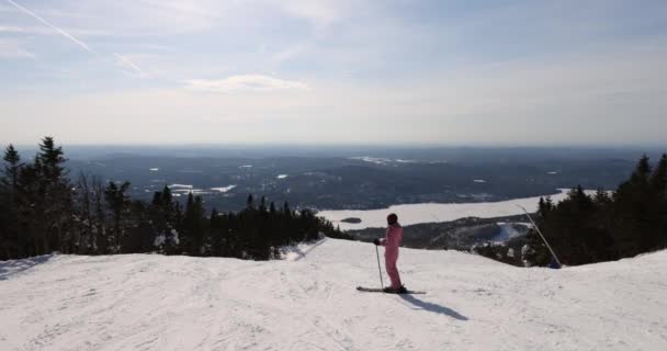 El esquí - la mujer en el viaje de vacaciones de esquí. Esquí alpino - esquiador mirando a la vista de la montaña contra la nieve cubierta de pistas y árboles. Esquí en invierno mientras disfruta de la vista de la naturaleza y el paisaje — Vídeos de Stock