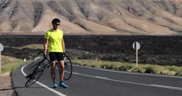 Naprawa rowerów rowerzysta człowiek po stronie naprawy dróg problem rower z kołem — Wideo stockowe
