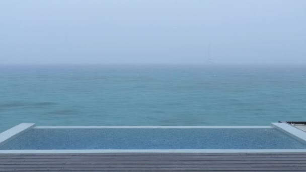 Rain on Vacation - video of luxury pool while raining — стоковое видео