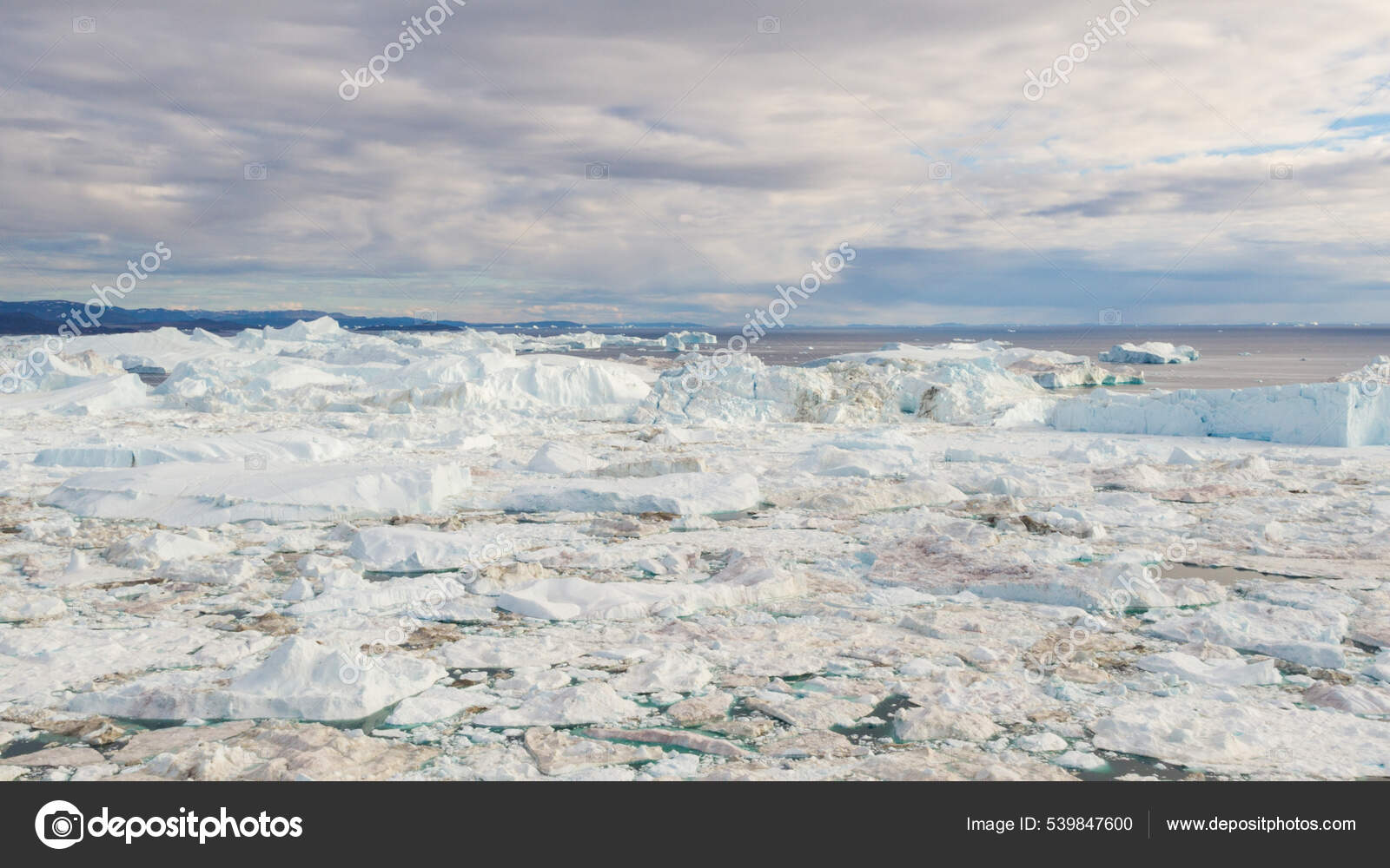 Climate Change and Global Warming. Iceberg from glacier in arctic nature landscape on Greenland. Icebergs in Ilulissat icefjord. Melting of glaciers and Greenland ice sheet cause sea levels rise. 539847600