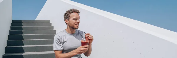 Man drinking red beet smoothie detox juice healthy lifestyle panoramic banner. Athlete young runner at outdoor stairs happy eating breakfast — Zdjęcie stockowe