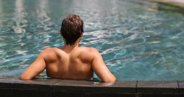 Retiro de spa de bem-estar de viagem de luxo - homem relaxante na piscina — Vídeo de Stock