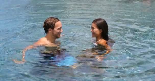 Honeymoon couple relaxing together - swimming pool — Stock Video