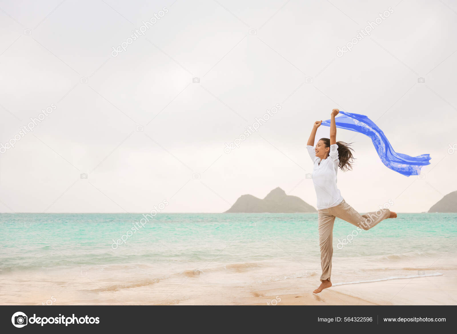 Freedom on beach happy carefree Asian woman jumping free in the