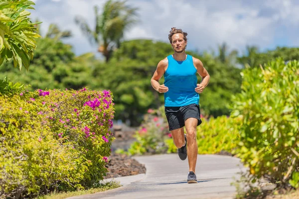 Fitness man getting in shape jogging outside on sidewalk training cardio for weight loss. Runner running in summer active lifestyle — Stock Photo, Image