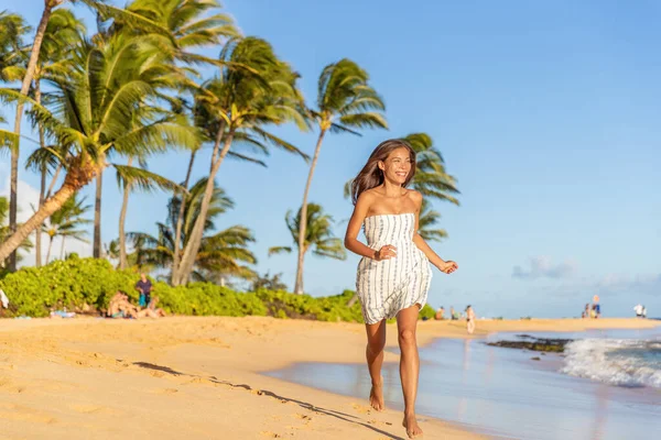 Summer vacation happy Asian woman running carefree on beach during Hawaii travel on Maui island wearing white dress at sunset — Stock Photo, Image