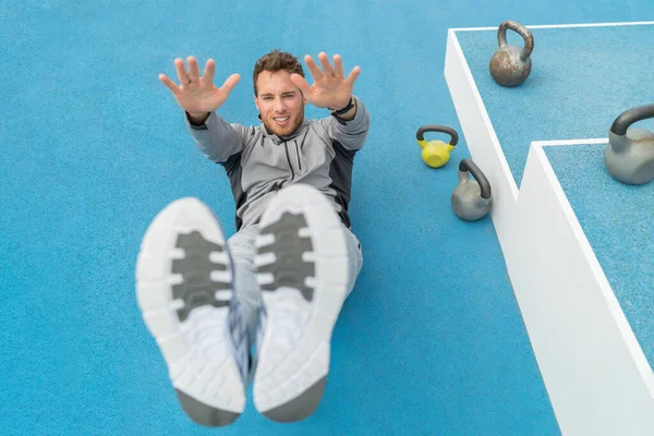 Abs exercise leg lift toe touch sit-up workout man strength training at fitness gym athletic stadium. Athlete working out crunches exercises for stomach muscles and weight loss — Stock Photo, Image