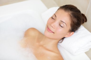 Bathing woman relaxing in bath clipart