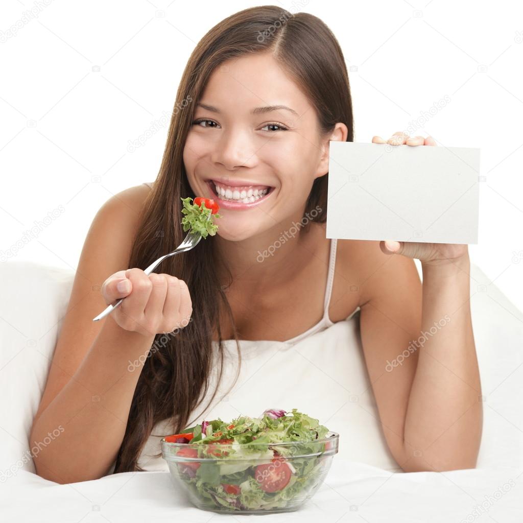 Woman Eating Salad Showing Copy Space Sign Stock Photo