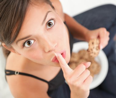Woman eating cookie clipart